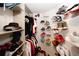 Walk-in closet showing shelves of shoes and hanging clothes at 10162 Benton Woods Dr, Covington, GA 30014