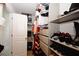 Walk-in closet with storage shelves, shoe racks, and hanging clothes at 10162 Benton Woods Dr, Covington, GA 30014
