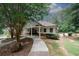 Inviting clubhouse with covered porch nestled within a tree-lined neighborhood, promising recreation and leisure at 10162 Benton Woods Dr, Covington, GA 30014