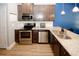 Well-equipped kitchen features stainless steel appliances and granite countertops at 10162 Benton Woods Dr, Covington, GA 30014