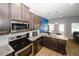 Well-equipped kitchen with stainless steel appliances, granite countertops, and modern lighting fixtures at 10162 Benton Woods Dr, Covington, GA 30014