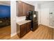 Modern kitchen with stainless steel appliances, granite countertops, and dark wood cabinets at 10162 Benton Woods Dr, Covington, GA 30014