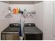 Laundry room with modern appliances, overhead storage, and a clean functional space at 10162 Benton Woods Dr, Covington, GA 30014