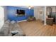 Cozy living room featuring stylish gray couches, a large wall-mounted TV, and modern ceiling fan at 10162 Benton Woods Dr, Covington, GA 30014