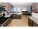 Open-concept kitchen and living area with stainless appliances, granite counters, and comfortable seating at 10162 Benton Woods Dr, Covington, GA 30014