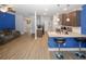 Open-concept living room and kitchen area with breakfast bar and modern stainless steel appliances at 10162 Benton Woods Dr, Covington, GA 30014