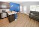 Open-concept floor plan with a breakfast bar island and a living area with a cozy sofa at 10162 Benton Woods Dr, Covington, GA 30014