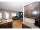 Open-concept kitchen and living room with modern cabinetry and a large TV at 10162 Benton Woods Dr, Covington, GA 30014
