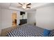 Bright main bedroom featuring a ceiling fan and attached bathroom at 10162 Benton Woods Dr, Covington, GA 30014