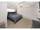 Bright main bedroom with tray ceiling, ceiling fan, and patterned bedding at 10162 Benton Woods Dr, Covington, GA 30014
