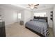 Spacious main bedroom with tray ceiling, ceiling fan, and sitting area at 10162 Benton Woods Dr, Covington, GA 30014