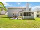 Spacious backyard with well-maintained lawn, patio, table set, and screened-in porch, perfect for outdoor relaxation at 1127 Oak Hollow Ct, Hampton, GA 30228