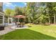 Beautiful backyard with patio, umbrella-covered table set, and screened-in porch, ideal for outdoor living and entertaining at 1127 Oak Hollow Ct, Hampton, GA 30228