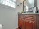 Stylish bathroom featuring a granite countertop, wooden vanity, and modern fixtures at 1127 Oak Hollow Ct, Hampton, GA 30228