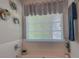 Bright bathroom featuring a tub, window with blinds, and stylish decor at 1127 Oak Hollow Ct, Hampton, GA 30228
