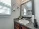 Stylish bathroom featuring a granite countertop, wooden vanity, and modern fixtures at 1127 Oak Hollow Ct, Hampton, GA 30228
