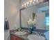 Modern bathroom vanity with double sinks, a framed mirror, and updated lighting at 1127 Oak Hollow Ct, Hampton, GA 30228