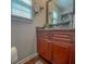 Stylish bathroom featuring a granite countertop, wooden vanity, and modern fixtures at 1127 Oak Hollow Ct, Hampton, GA 30228