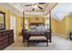 Inviting bedroom with tray ceilings, a ceiling fan, and comfortable decor at 1127 Oak Hollow Ct, Hampton, GA 30228