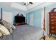 Charming bedroom with blue walls, tray ceilings, a ceiling fan, and a four-poster bed at 1127 Oak Hollow Ct, Hampton, GA 30228