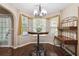 Charming breakfast nook with bay window, chandelier, and stylish furniture at 1127 Oak Hollow Ct, Hampton, GA 30228