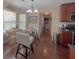 Open dining area with glass table, chairs and hardwood flooring located adjacent to a kitchen space at 1127 Oak Hollow Ct, Hampton, GA 30228