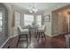 Cozy dining area featuring a glass table, chairs and bright natural light from the window at 1127 Oak Hollow Ct, Hampton, GA 30228