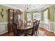 Elegant dining room showcasing a chandelier, bay window, and decorative accents at 1127 Oak Hollow Ct, Hampton, GA 30228