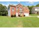 Lovely two-story brick home with a manicured lawn and attached garage at 1127 Oak Hollow Ct, Hampton, GA 30228