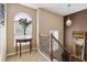 Inviting hallway featuring a decorative window, iron railing, and neutral color palette at 1127 Oak Hollow Ct, Hampton, GA 30228