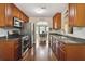 Open-concept kitchen with stainless steel appliances and sightlines to the dining area at 1127 Oak Hollow Ct, Hampton, GA 30228
