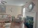 Cozy living room featuring an armchair, fireplace, and neutral decor at 1127 Oak Hollow Ct, Hampton, GA 30228