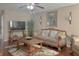 Bright living room featuring hardwood floors, neutral walls, and a large television at 1127 Oak Hollow Ct, Hampton, GA 30228