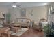 Bright living room featuring hardwood floors, neutral walls, and fireplace at 1127 Oak Hollow Ct, Hampton, GA 30228