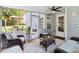 Inviting screened-in porch features cozy seating and outdoor view; open the door to relaxation and entertainment at 1127 Oak Hollow Ct, Hampton, GA 30228