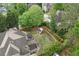 Aerial view of the home's backyard featuring mature trees, a gazebo, and an umbrella covered outdoor seating area at 1199 Kenway Se Cir, Smyrna, GA 30082