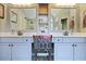 Bright bathroom with double sinks, mirrors, and stylish fixtures and vanity at 1199 Kenway Se Cir, Smyrna, GA 30082