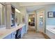 Stylish bathroom showcasing double vanity with views to the bedroom and soaking tub at 1199 Kenway Se Cir, Smyrna, GA 30082