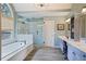 Luxurious bathroom featuring a soaking tub, glass enclosed shower and double vanity at 1199 Kenway Se Cir, Smyrna, GA 30082