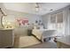 Bright bedroom with natural light and ceiling fan, decorative map tapestry, dresser and large windows with custom shades at 1199 Kenway Se Cir, Smyrna, GA 30082