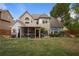 Back exterior of home with a large yard, patio area, outdoor seating, screened-in porch, and mature trees at 1199 Kenway Se Cir, Smyrna, GA 30082