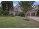 Beautiful home boasting a well-maintained lawn and a two-car garage, set within a peaceful and verdant surrounding landscape at 1199 Kenway Se Cir, Smyrna, GA 30082