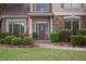 Close-up highlighting a welcoming front door framed by manicured landscaping, stone accents, and an inviting walkway at 1199 Kenway Se Cir, Smyrna, GA 30082