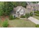 Charming two-story home with lush front lawn, landscaped bushes, and basketball hoop on the driveway at 1199 Kenway Se Cir, Smyrna, GA 30082