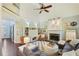 Spacious living room boasts a stone fireplace and vaulted ceilings with a stylish ceiling fan at 1199 Kenway Se Cir, Smyrna, GA 30082