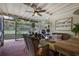 Enjoy the outdoors on this screened-in porch featuring brick floors, comfortable seating, and a ceiling fan at 1199 Kenway Se Cir, Smyrna, GA 30082