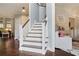 Elegant staircase featuring hardwood floors, leading to an upper level with access to a stylishly decorated living area at 1199 Kenway Se Cir, Smyrna, GA 30082