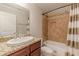 Cozy bathroom features a granite countertop, tiled shower, and striped shower curtain at 1303 Hill Se St, Atlanta, GA 30315
