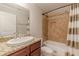 Granite vanity and neutral-tiled shower/tub combination in the bathroom at 1303 Hill Se St, Atlanta, GA 30315