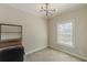 Bright bedroom with a modern light fixture and a nice window view at 1303 Hill Se St, Atlanta, GA 30315
